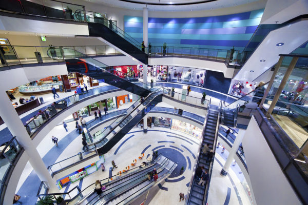 Modern shopping mall interior. Busy sale time